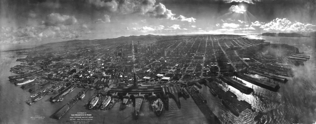 San Francisco lies in ruins on May 28, 1906, about six weeks after the 1906 San Francisco earthquake and fire. It was taken from a camera suspended on a kite, perhaps 1,000 feet above the city. It is one of the most well-known photographs of George R. Lawrence (see biography for more information about the technique used). The tower of the Ferry Building can be seen at the bay end of Market Street, which can be clearly seen all the way to the foothills of Twin Peaks. The water in the foreground is San Francisco Bay, with the Golden Gate to the right, rear. Note the absence of the Golden Gate Bridge and the San Francisco-Oakland Bay Bridge, which had yet to be constructed.